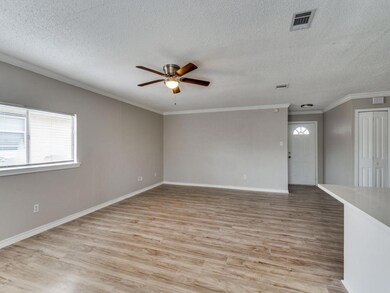 Spare room featuring crown molding, visible vents,