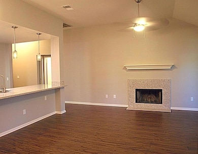 Unfurnished living room featuring a ceiling fan, 