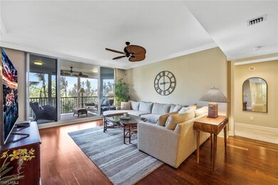 Living room with crown molding, floor to ceiling w