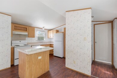 This photo showcases a cozy kitchen with wood cabi