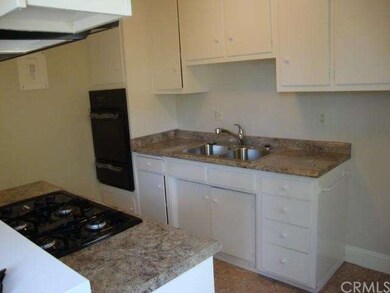 Freshly painted kitchen features granite look coun