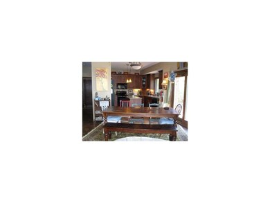 Dining area with kitchen in background