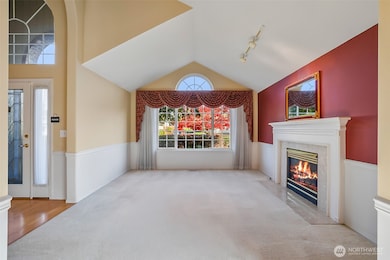 Vaulted living with gas fireplace. Custom wood mantal