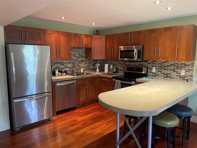 Kitchen featuring a sink, light countertops, appl