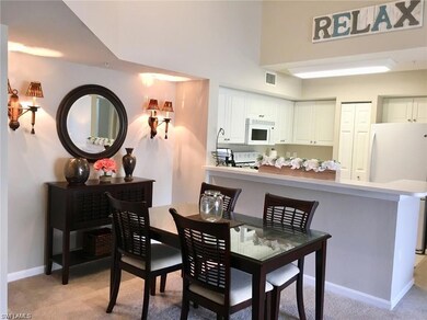 Carpeted living room with ceiling fan and lofted ceiling