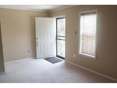 Living room with windows across the front and wood