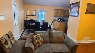 Dining area featuring dark wood finished floors and a chandelier