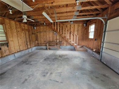 Oversized garage with stairs to loft.