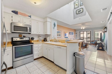 Kitchen featuring stainless steel appliances, a si