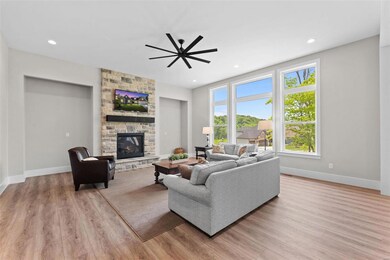 Gather in the great room with a stone gas fireplac