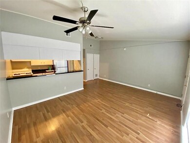 Unfurnished living room featuring wood finished f