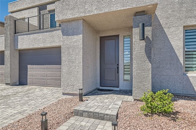 Property entrance with stucco siding and a garage