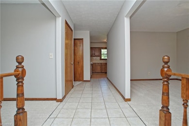 From front entryway the kitchen is in the back of 