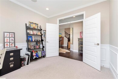 The study features french doors which open into the entryway.