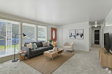 Living room featuring light colored carpet and baseboards