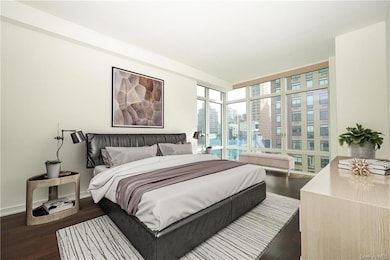 Bedroom featuring dark hardwood / wood-style floors and floor to ceiling windows