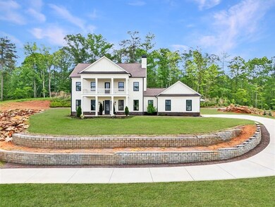 Greek revival house with a balcony, a chimney, a f
