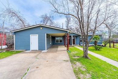 View of front of home featuring a carport, concre