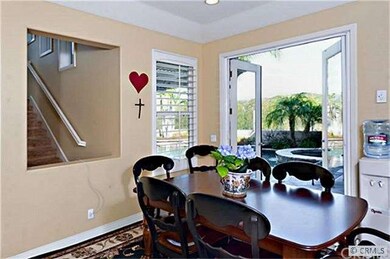 French Doors open to the stone Patio and Pool area