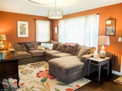 Spacious living room with wood flooring and a pict