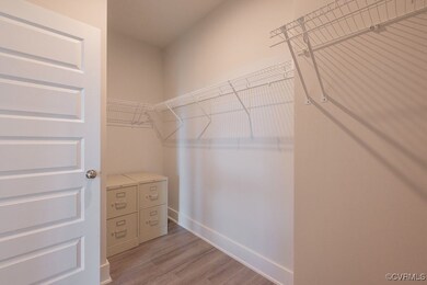 Walk in closet featuring wood finished floors