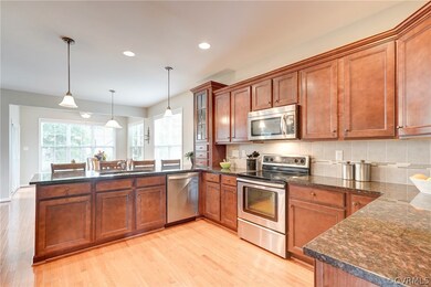 Open kitchen with hw floors, granite tops, tile ba