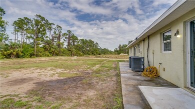 View of yard featuring cooling unit and a patio ar