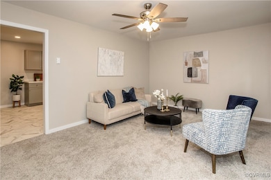 Living room featuring a ceiling fan, light marble