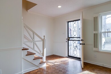 Foyer entrance featuring parquet floors, crown mol