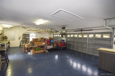 Oversized, three car attached garage, epoxy floor, third bay is higher and can accommodate a car lift. Insulated above with plywood for storage placement.