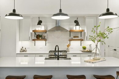 Kitchen with floating shelves and pendant lighting