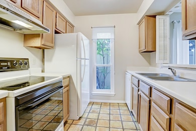 This homey kitchen offers plenty of natural lighting, counter space, and cabinets to truly make this your workspace when cooking.
