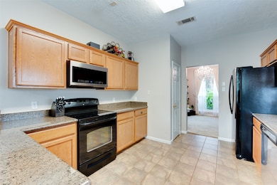 This kitchen features modern appliances, granite c