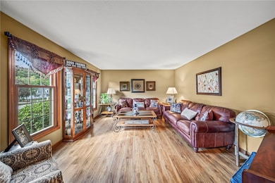 Living area featuring light wood finished floors and baseboards