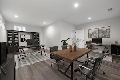 Office space featuring wood finished floors and recessed lighting