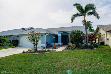 Single story home featuring a front lawn, an attac
