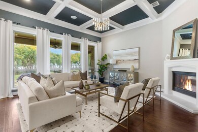 The gorgeous living room has coffered ceilings, ga