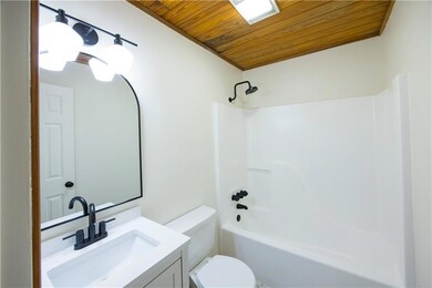 Upstairs bathroom with vanity, toilet, wooden ceil