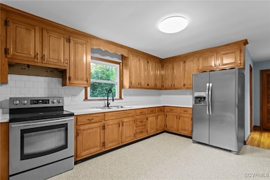 Kitchen featuring light countertops, appliances wi