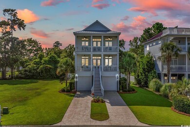 Coastal inspired home featuring a yard, a garage, 