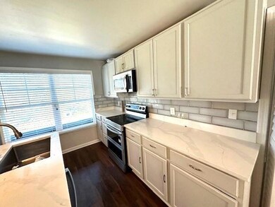 Kitchen with dark hardwood / wood-style flooring, 