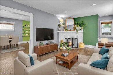Living room featuring a wealth of natural light, a fireplace, and hardwood / wood-style flooring