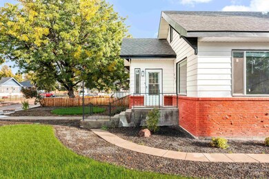 View of front of home featuring a shingled roof and brick siding