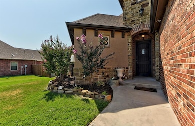 Entrance to property featuring fence, stone siding