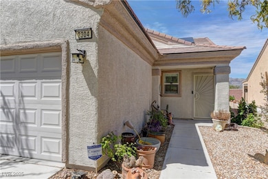 Entrance to property with stucco siding and an att