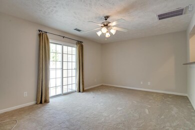 The Living Room is located on the back of the home with sliding doors that lead to the private patio.