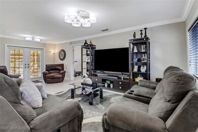 Living area with french doors, an inviting chandel