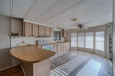 Kitchen with sink, a textured ceiling, kitchen pen