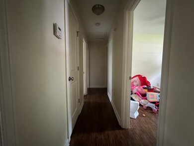 Hall with dark wood-type flooring