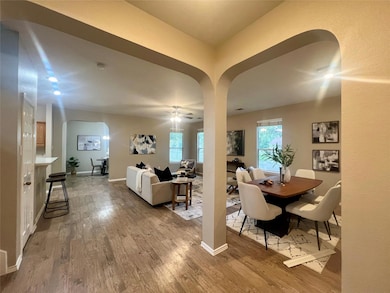 Dining area with arched walkways, wood finished f
